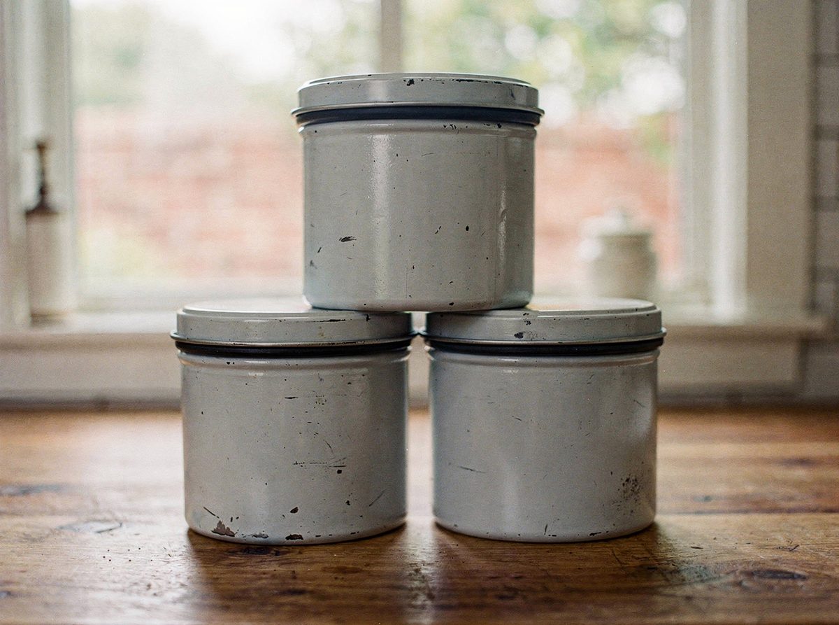 Set of three stackable enamel storage canisters with gasket lids on a kitchen counter